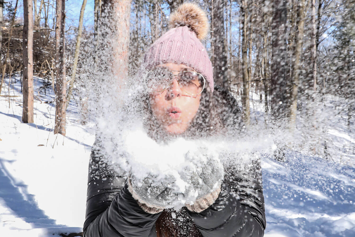 Woman Blowing Snow at Camera