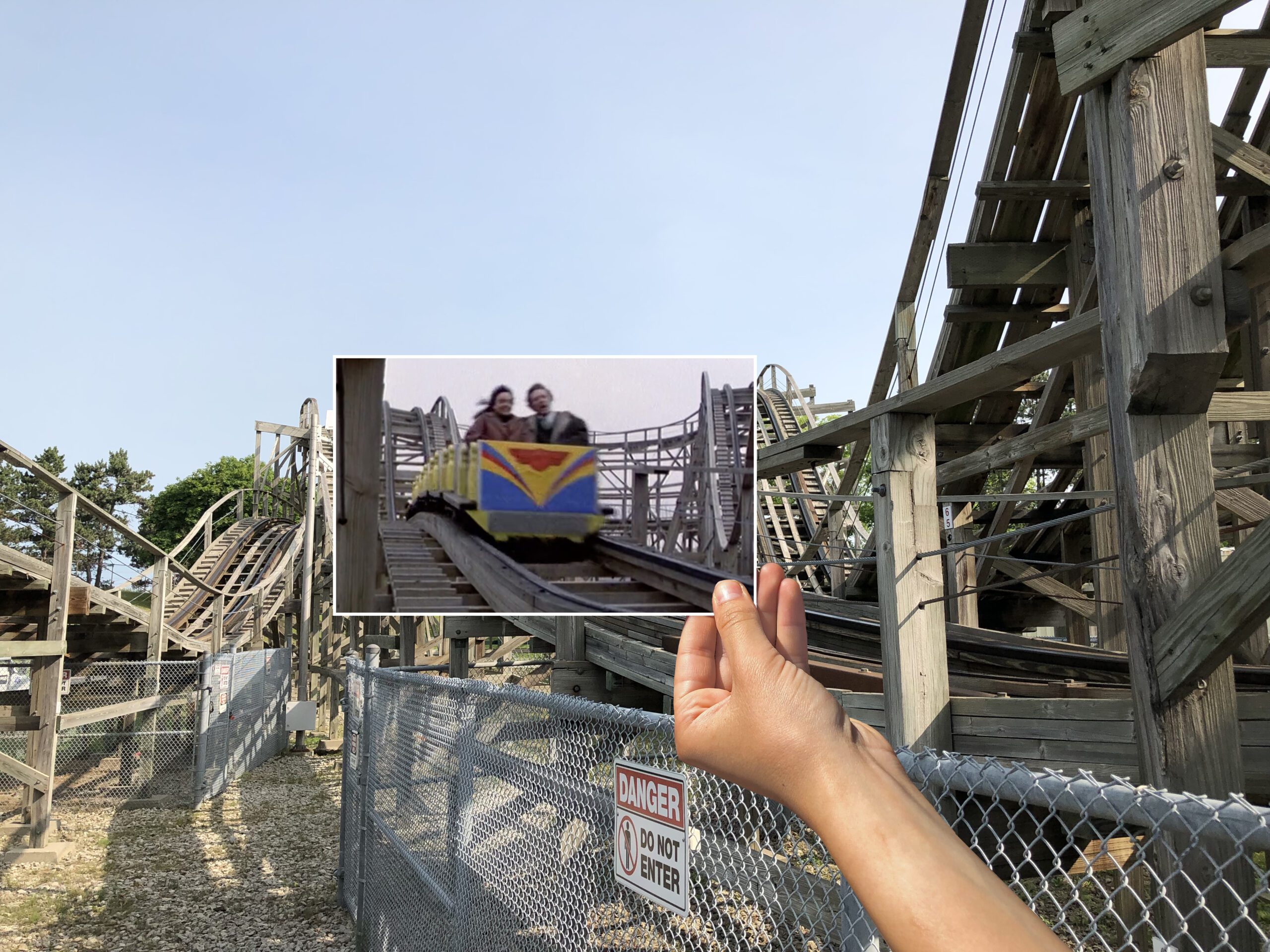A hand holding up a photograph which contains a still from The Dead Zone, perfectly matching the background of where the footage was shot.