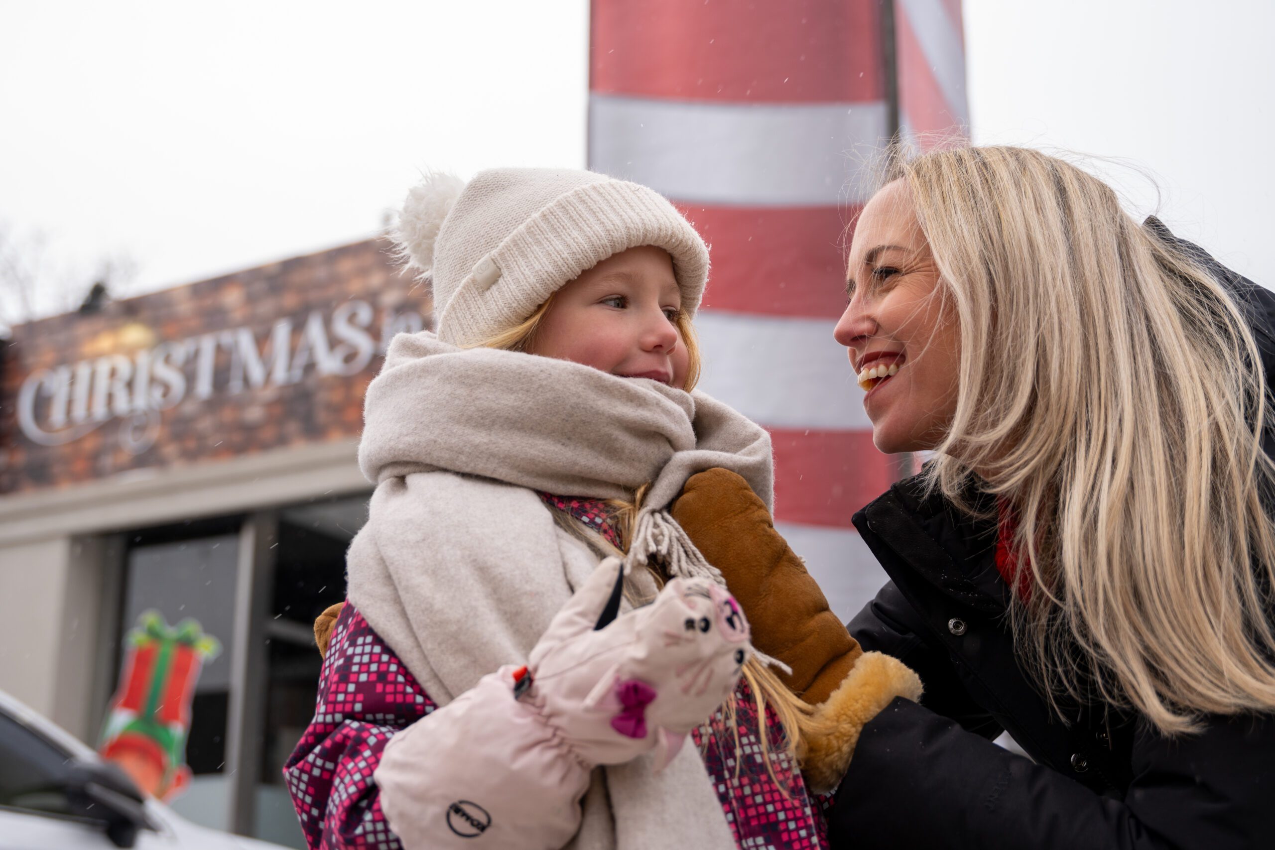 Image of a mother and daughter bundled up at an outdoor Christmas market