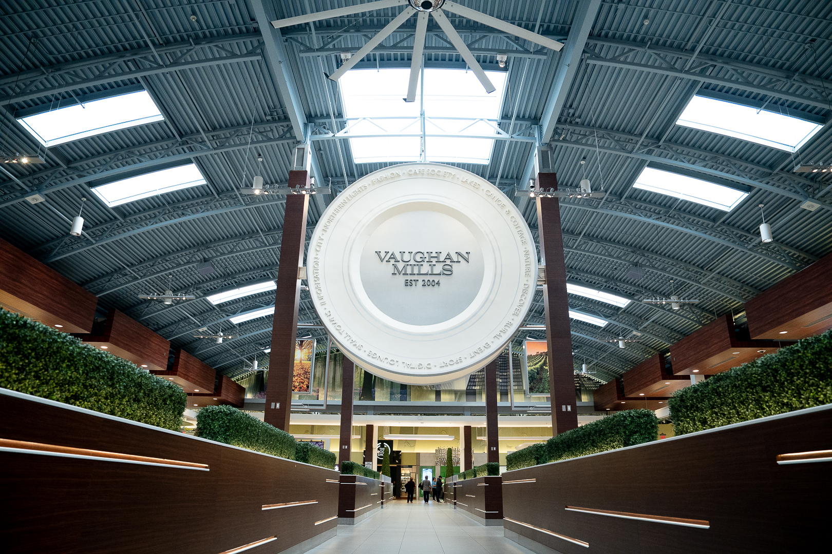 Image of a Vaugh Mills Shopping Centre sign hanging from the ceiling inside the mall