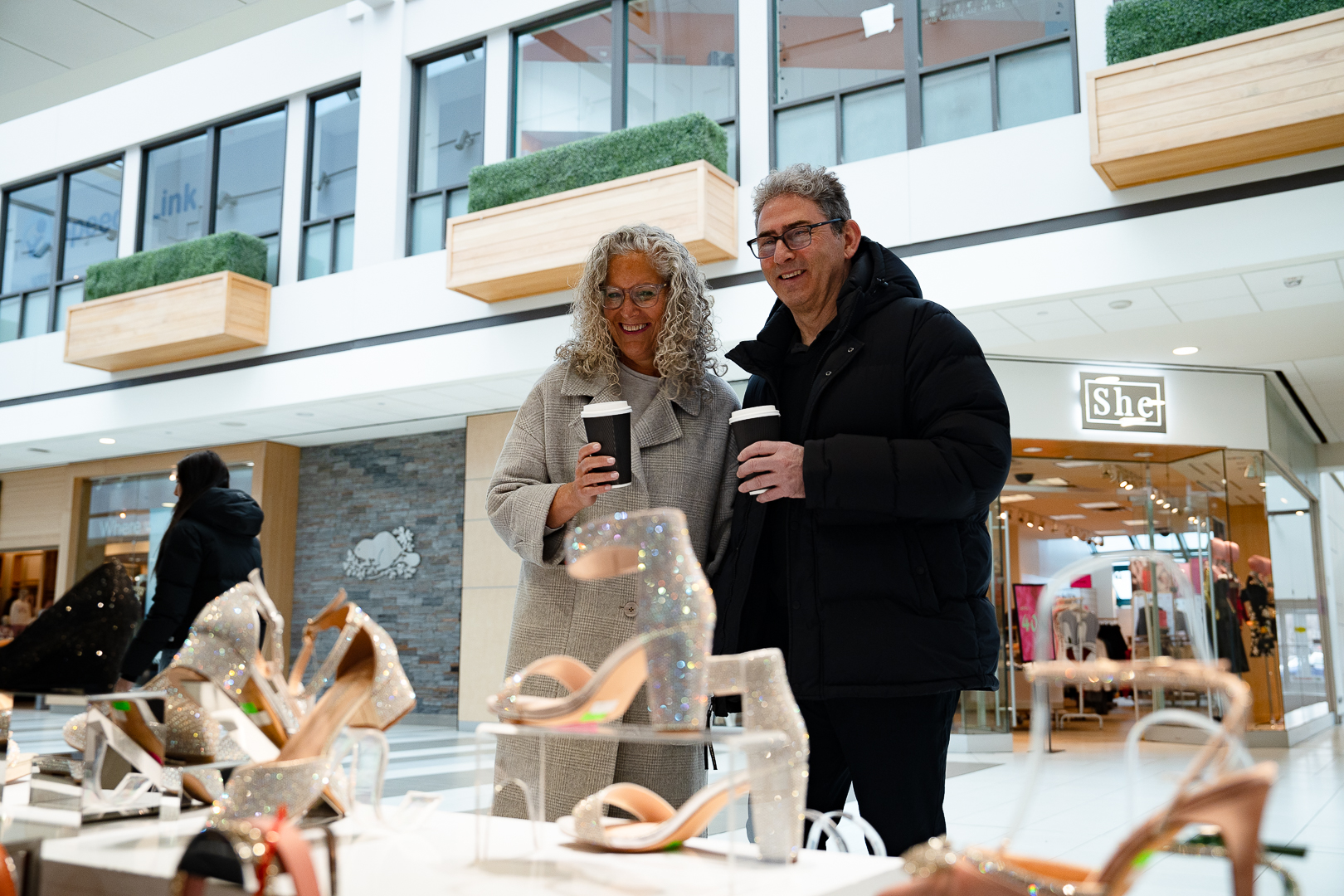 Image of a couple looking in a shop window at a mall