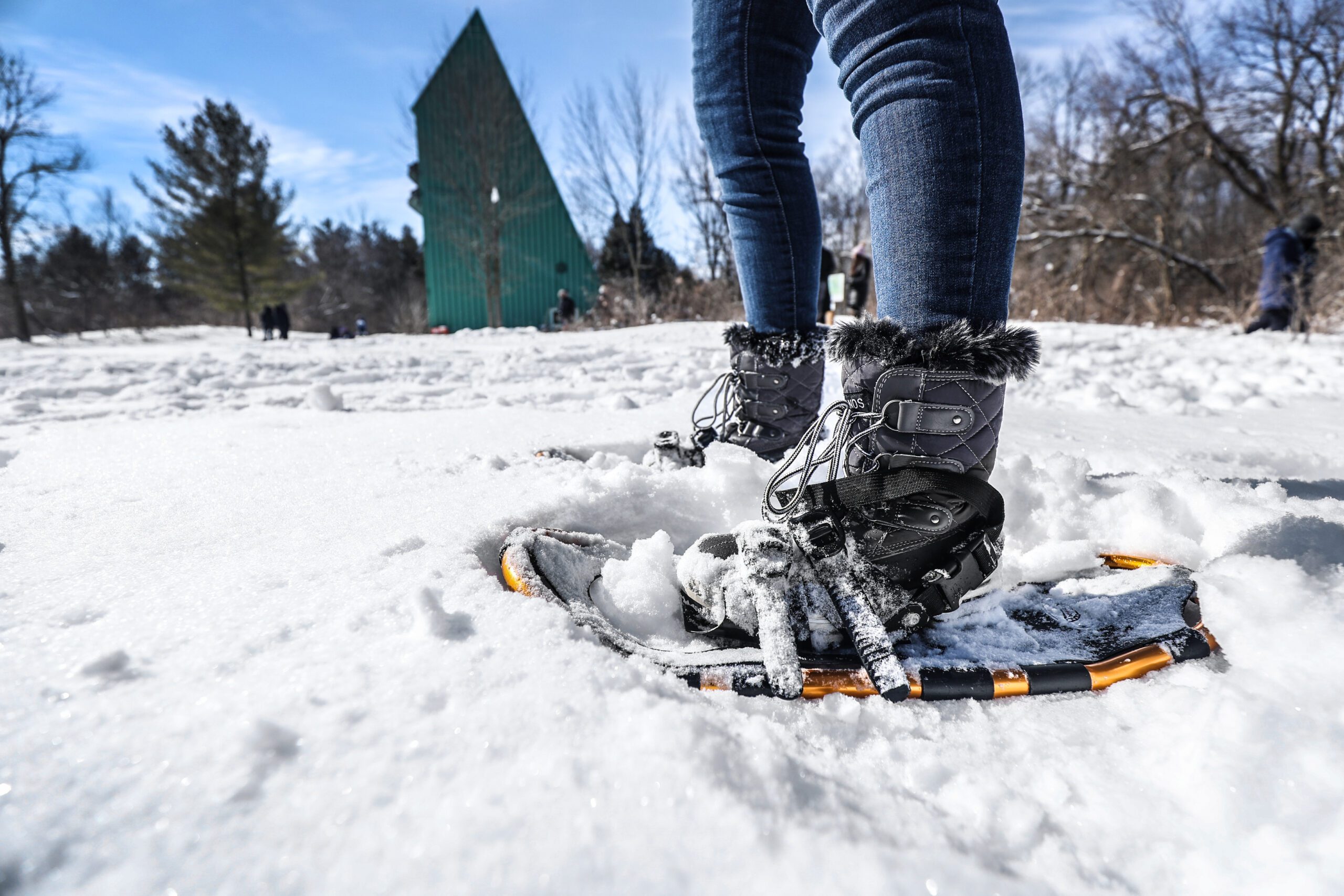 Image taken at ground level of a person walking in snowshoes
