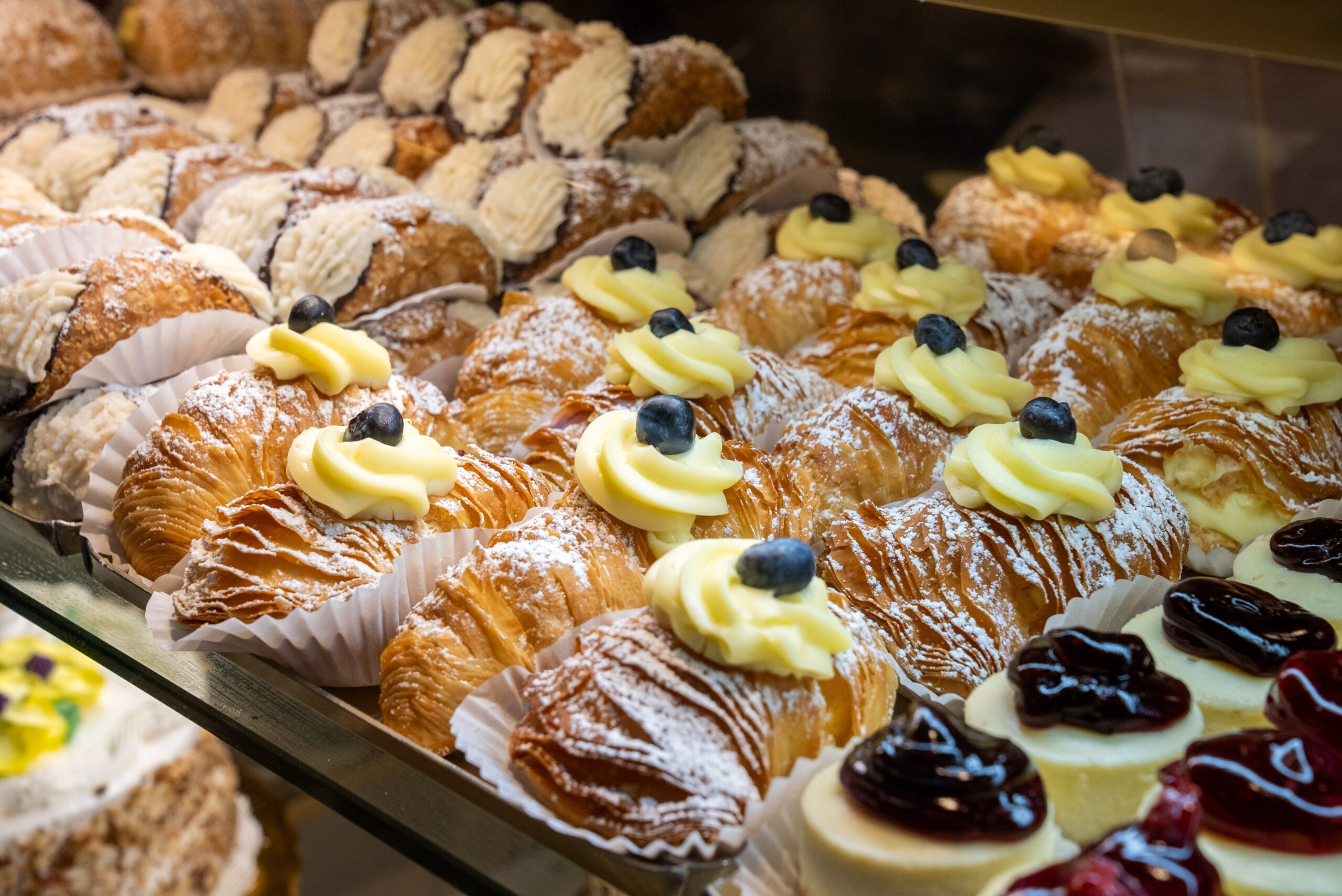 Image of mouthwatering pastries lined up in a display case