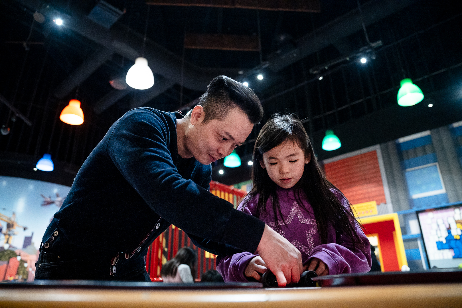 Image of a parent and their child playing with building blocks