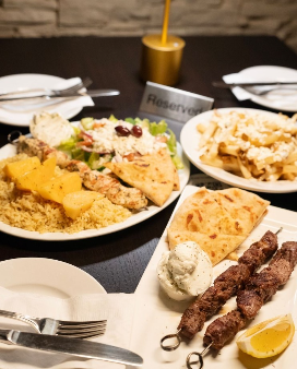 Image of a table in a restaurant full of plates of foot