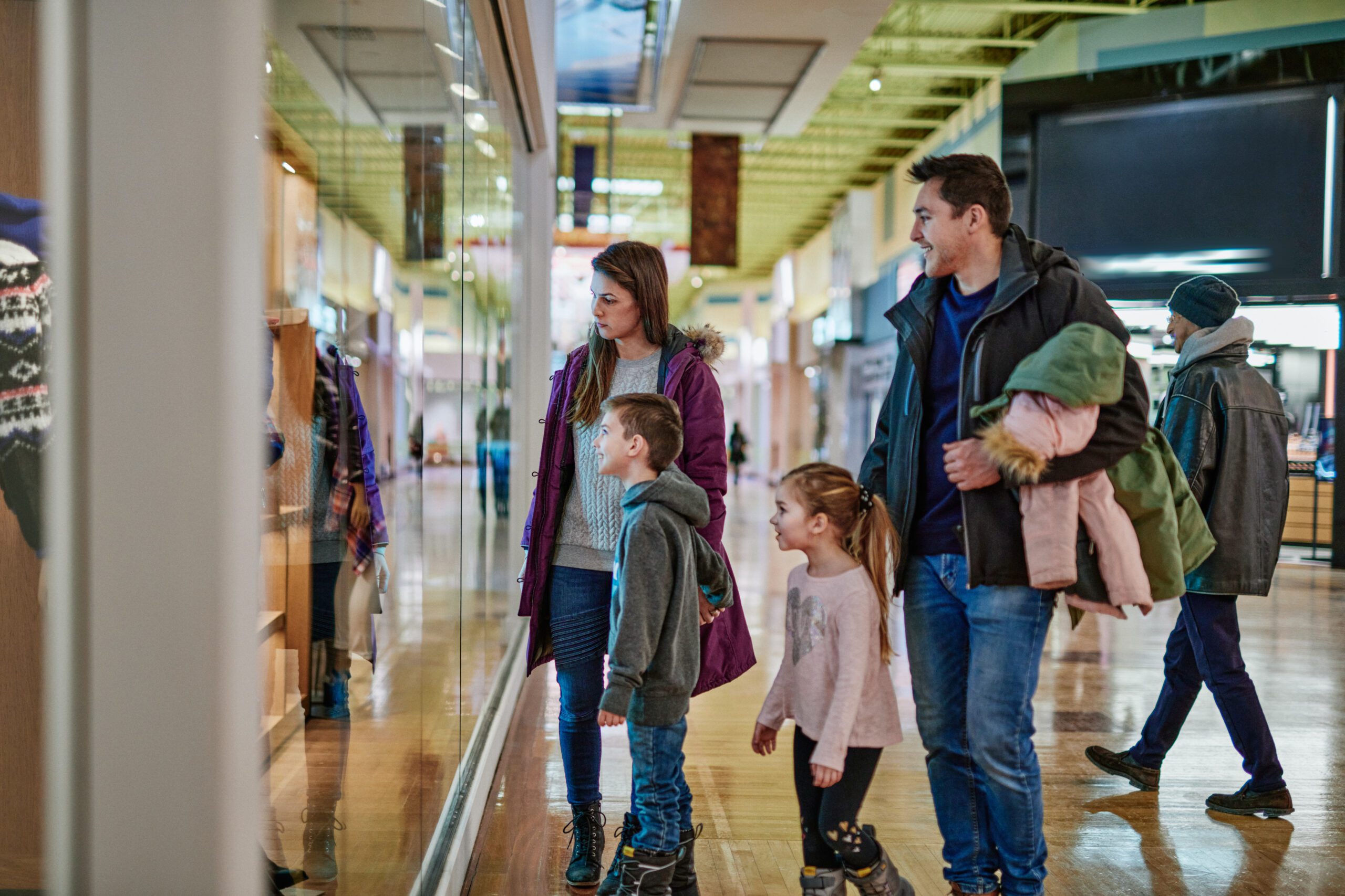 Image of a family of four shopping at a mall