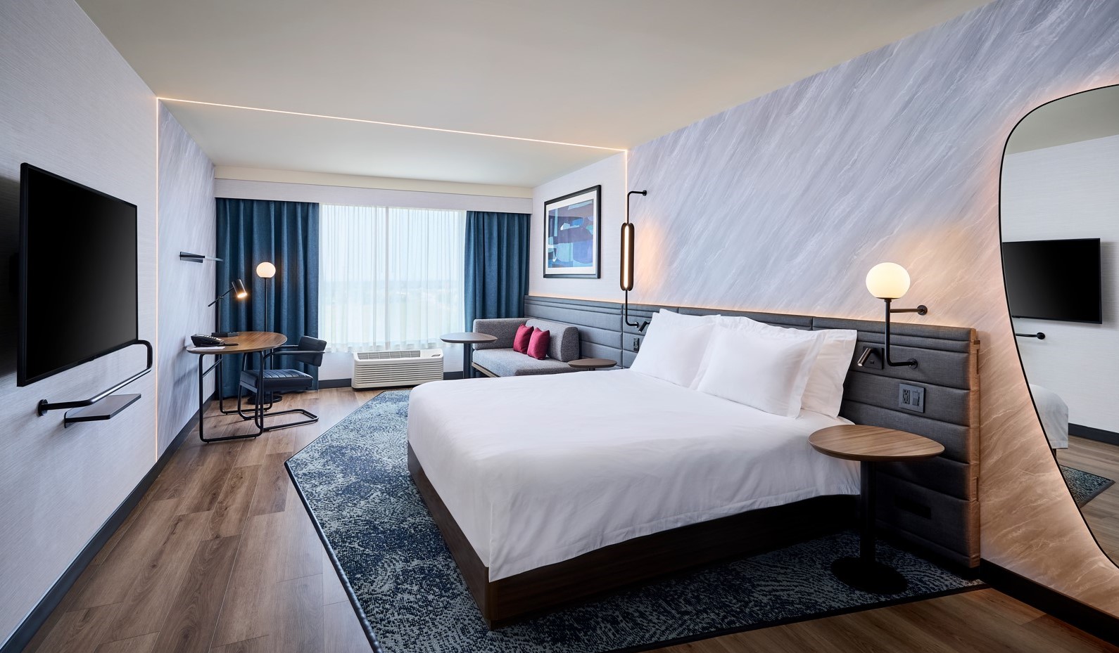 Image of the interior of an upscale hotel room with one king bed