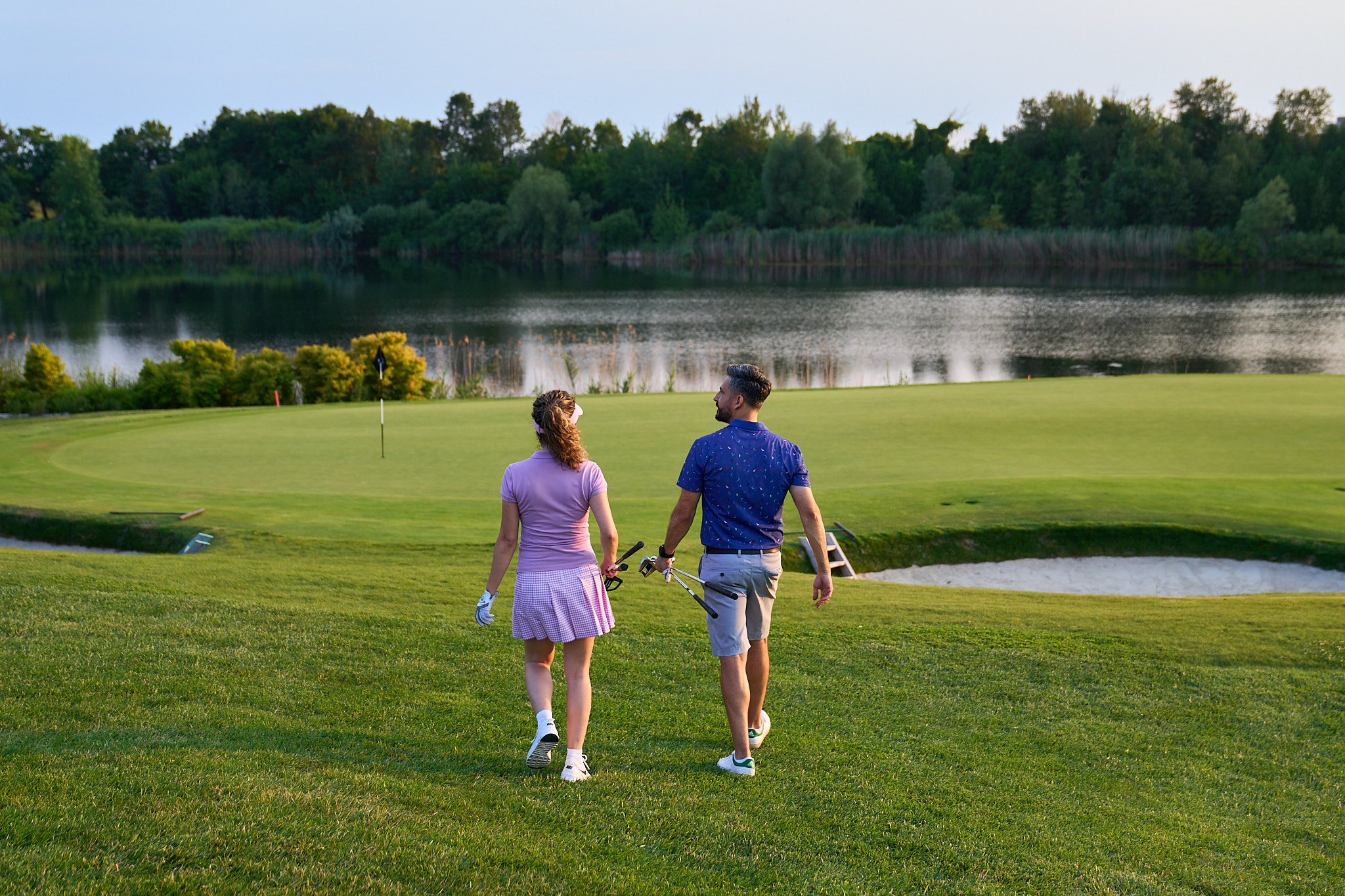 Image of a couple walking on a golf course
