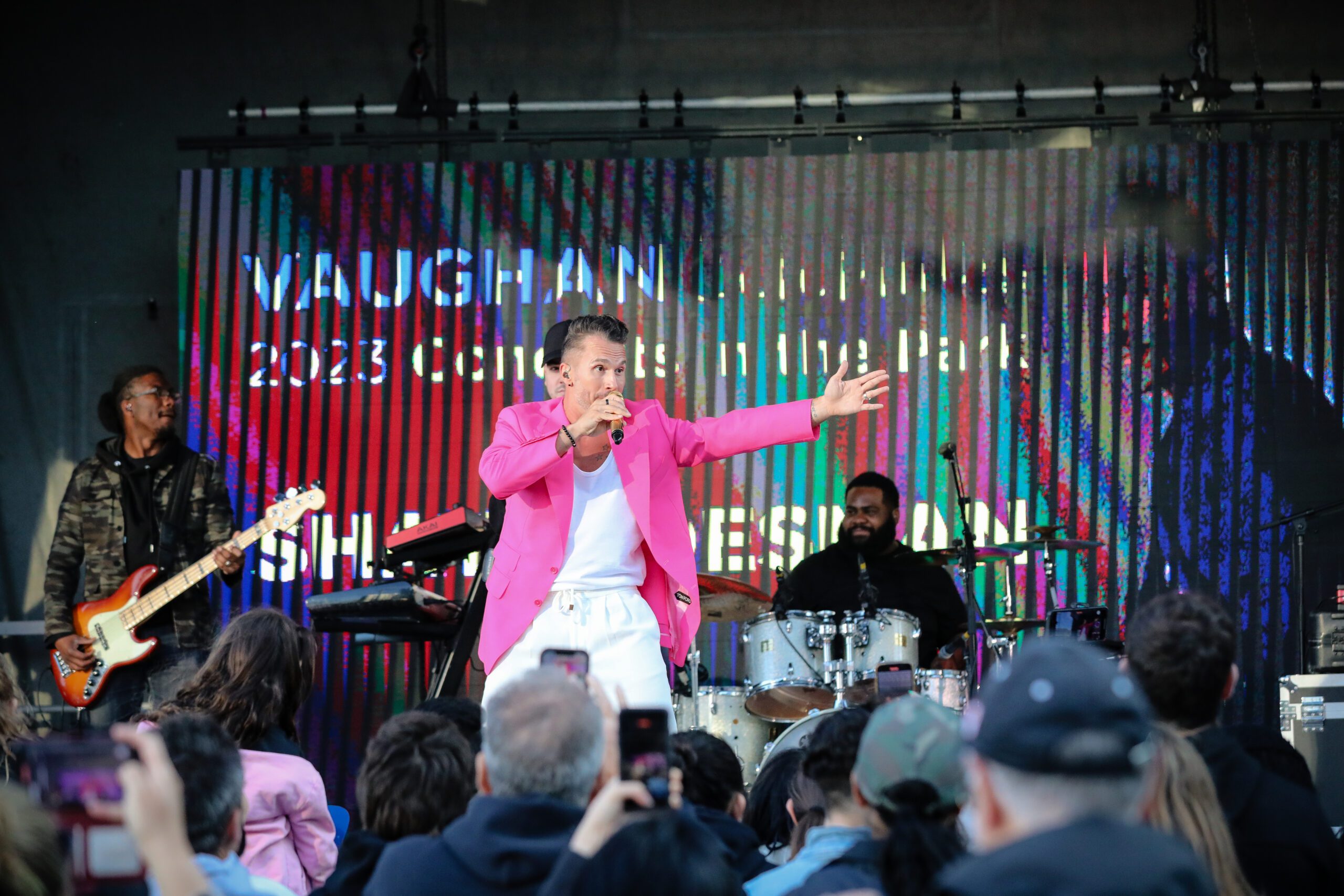 Image of Shawn Desman performing on stage with a big crowd of people watching