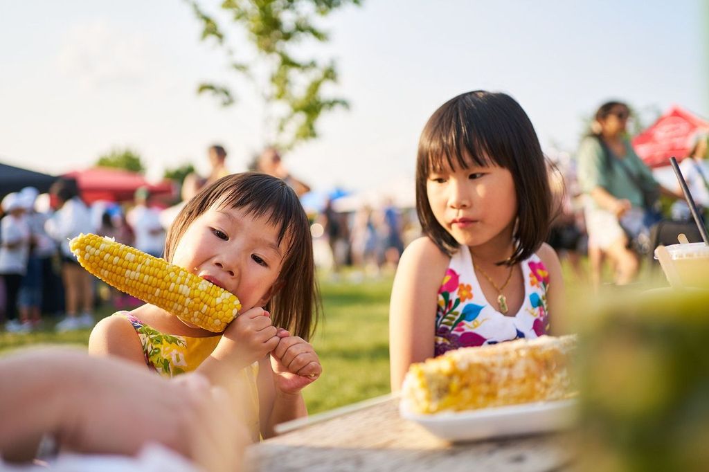 two girls eating at picnic
